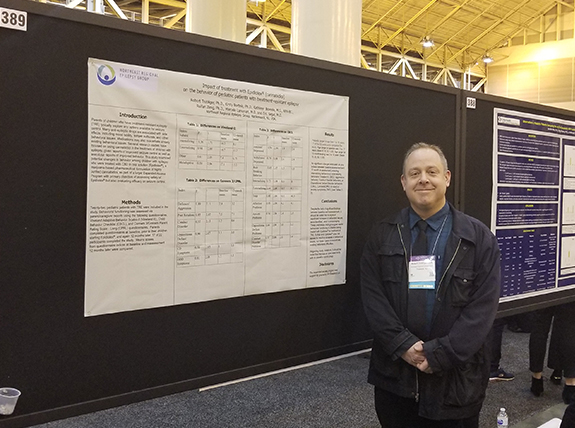 Dr. Robert Trobliger next to his poster on Epidiolex and cognition