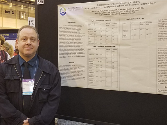Dr. Robert Trobliger next to his poster on behavior and Epidiolex 